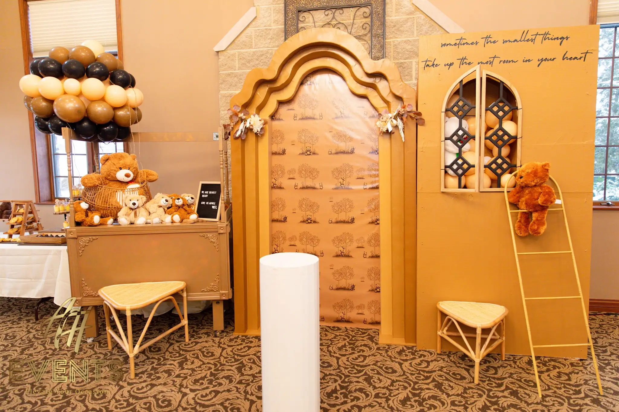 Bear-themed baby shower backdrop — a gold storybook house with an arched window, flanked by teddy bears, balloons and a gold chest