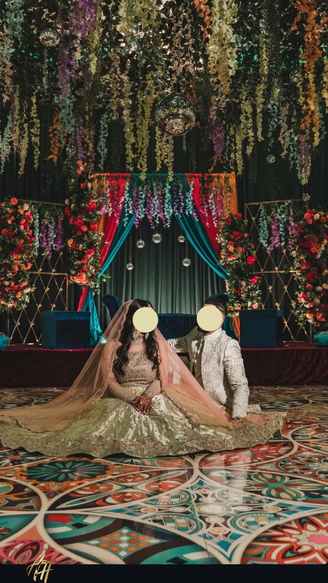 Couple sitting on top of a kaleidoscope dance floor