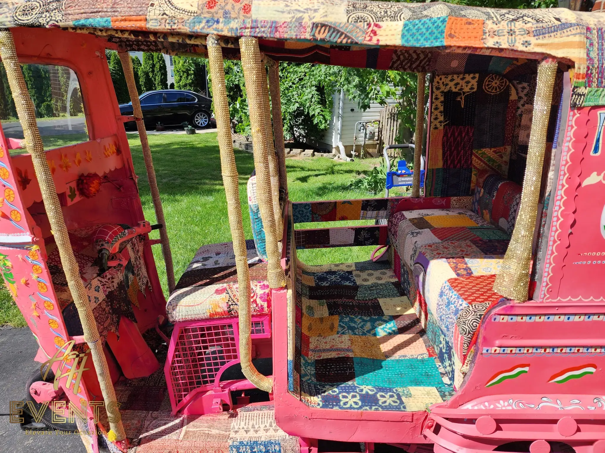 Interior of the auto rickshaw showing colorful patchwork quilted seats and panels