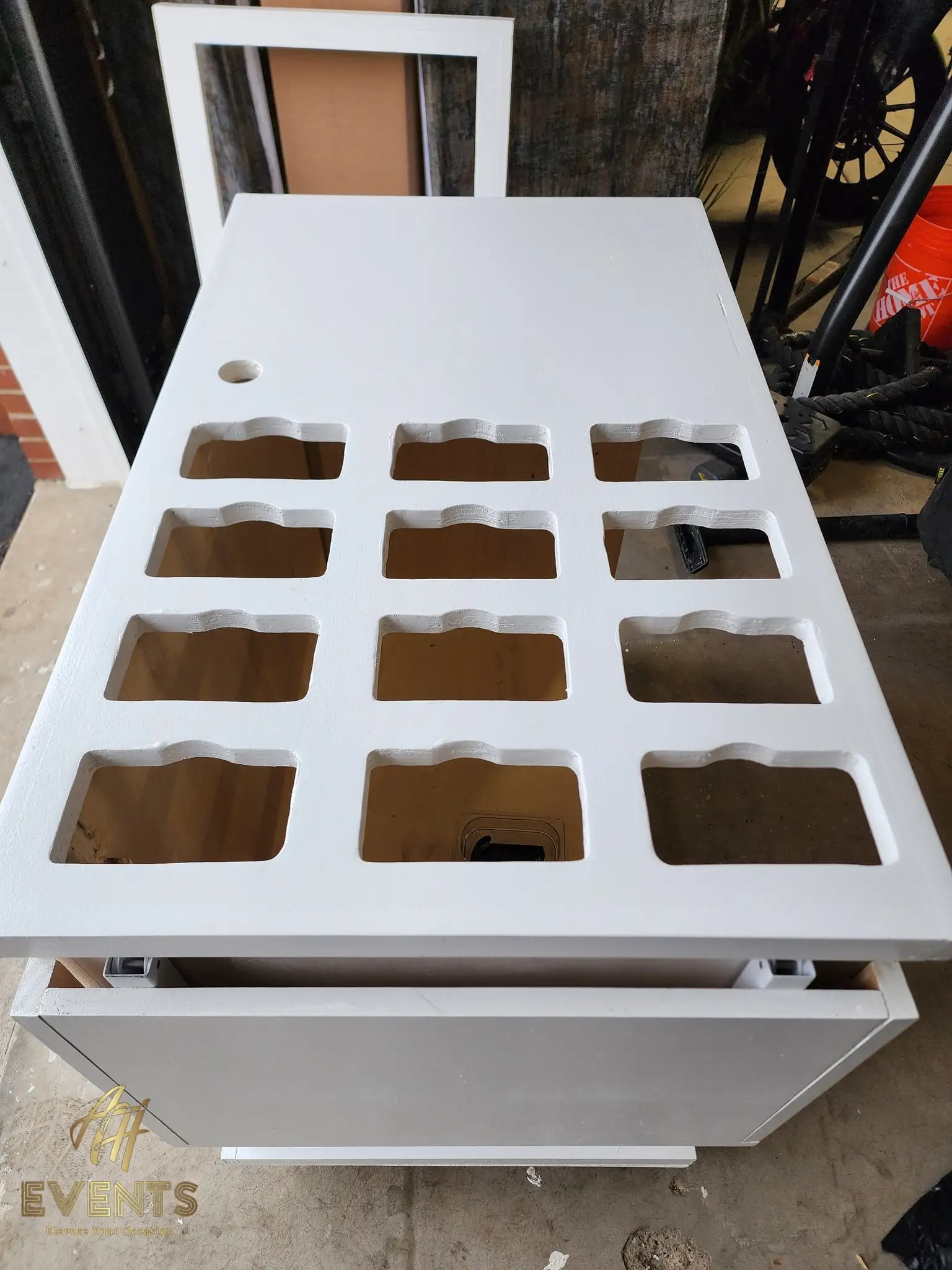 Angled view of the white cart top showing a 4-by-3 grid of scalloped rectangular cup wells and a round hole