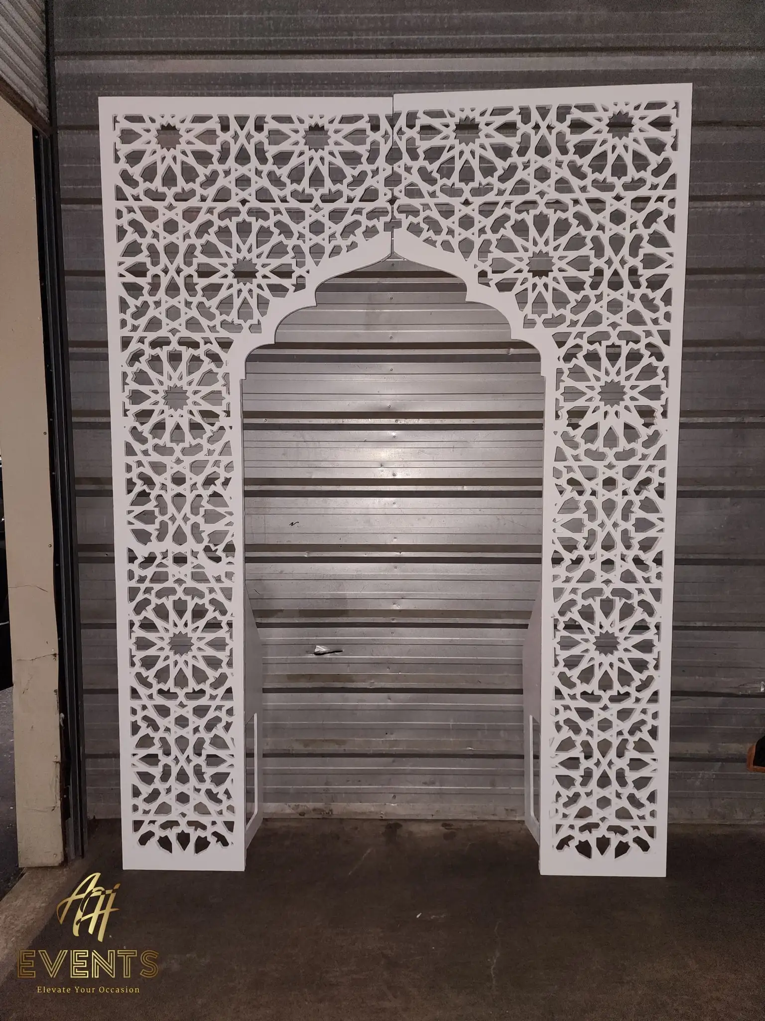 White star-lattice matrix arch shown as two split panels leaning in the workshop