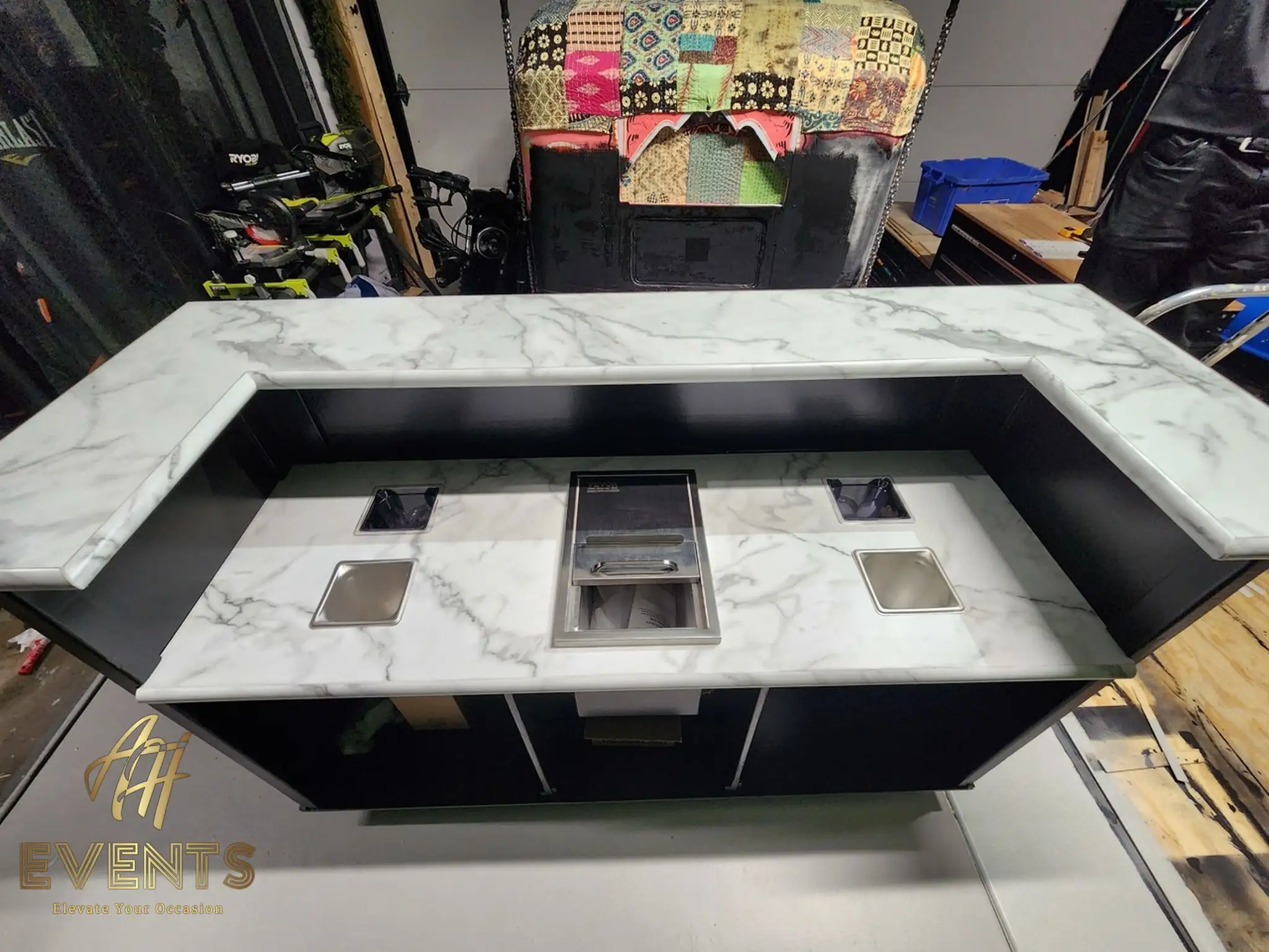 The Bobawala bubble tea cart in the workshop — marble counter with a central cup-dispenser well, ice well and condiment insets over a black body