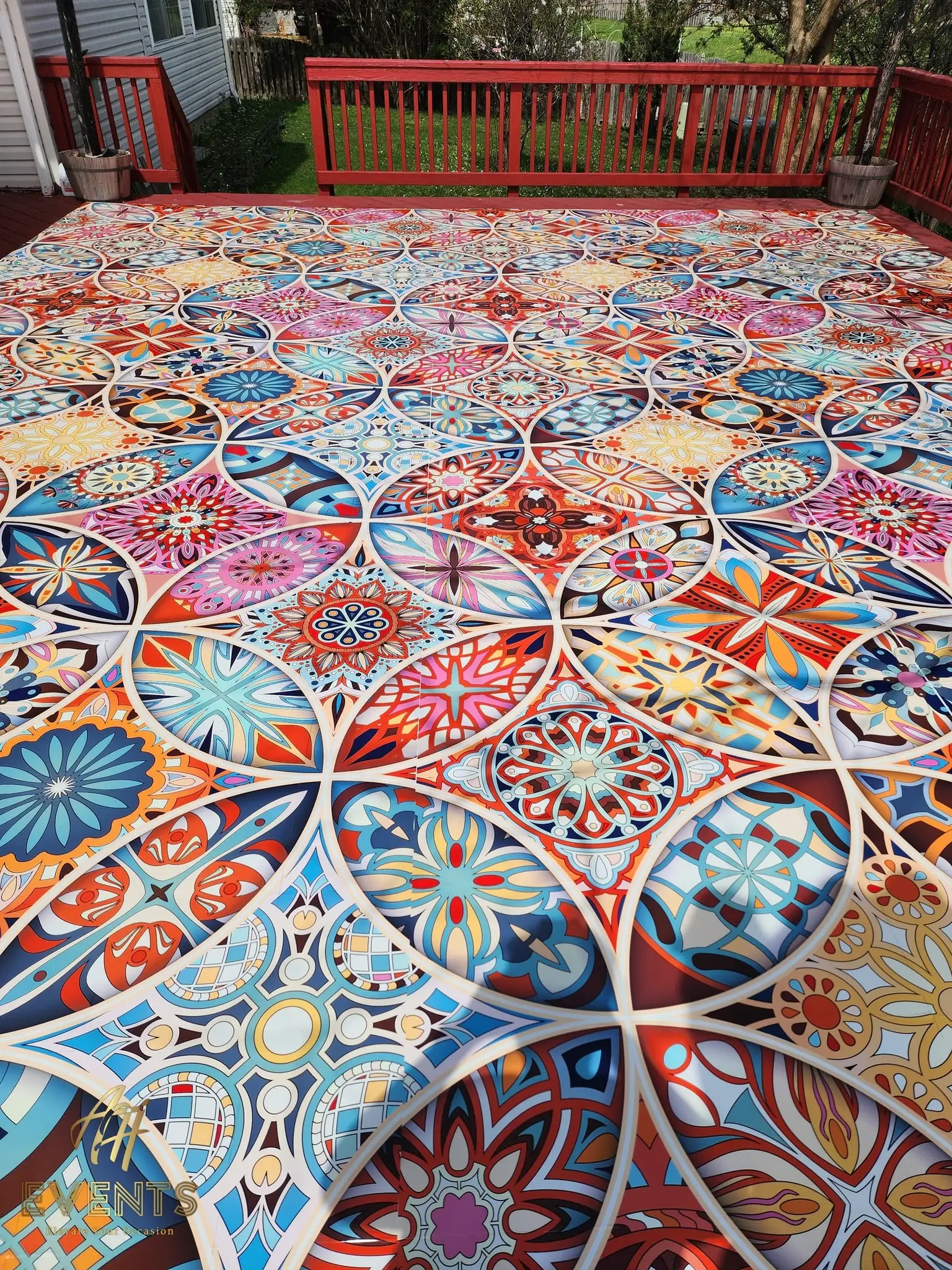 Overhead angle of the Kaleidoscope floor on a wooden deck bordered by a red railing