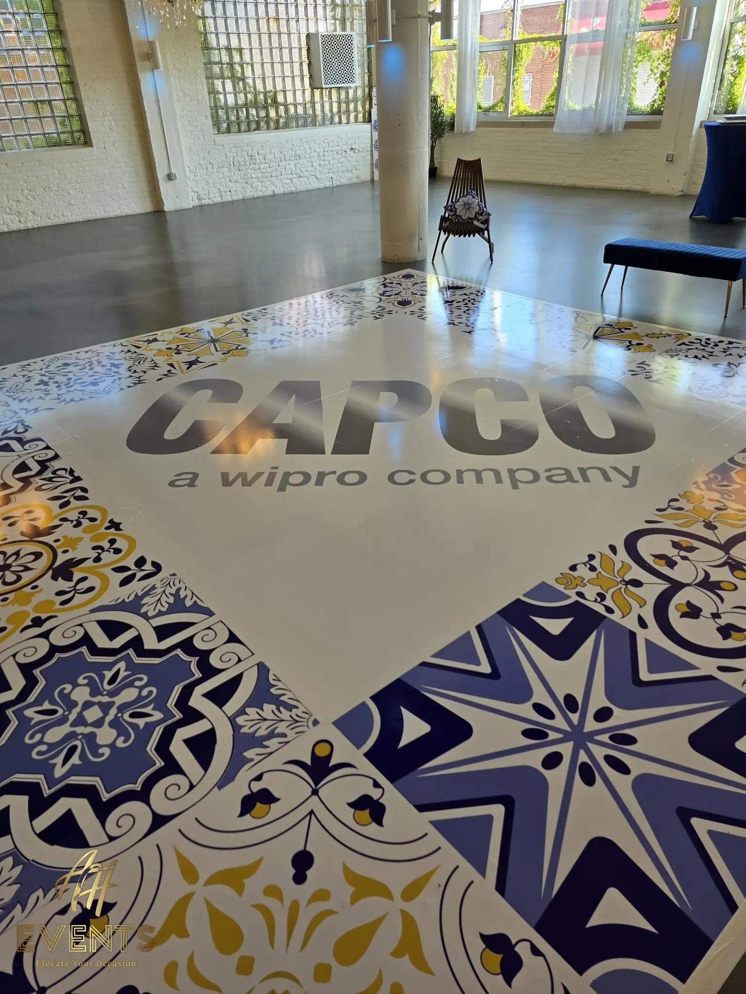 Close view of the CAPCO logo on the blue-and-yellow tiled dance floor