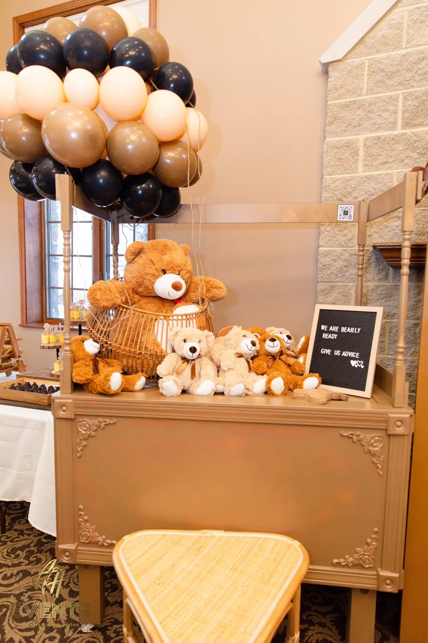 Gold dessert console topped with teddy bears, a balloon cluster and a 'We are bearly ready, give us advice' letter board
