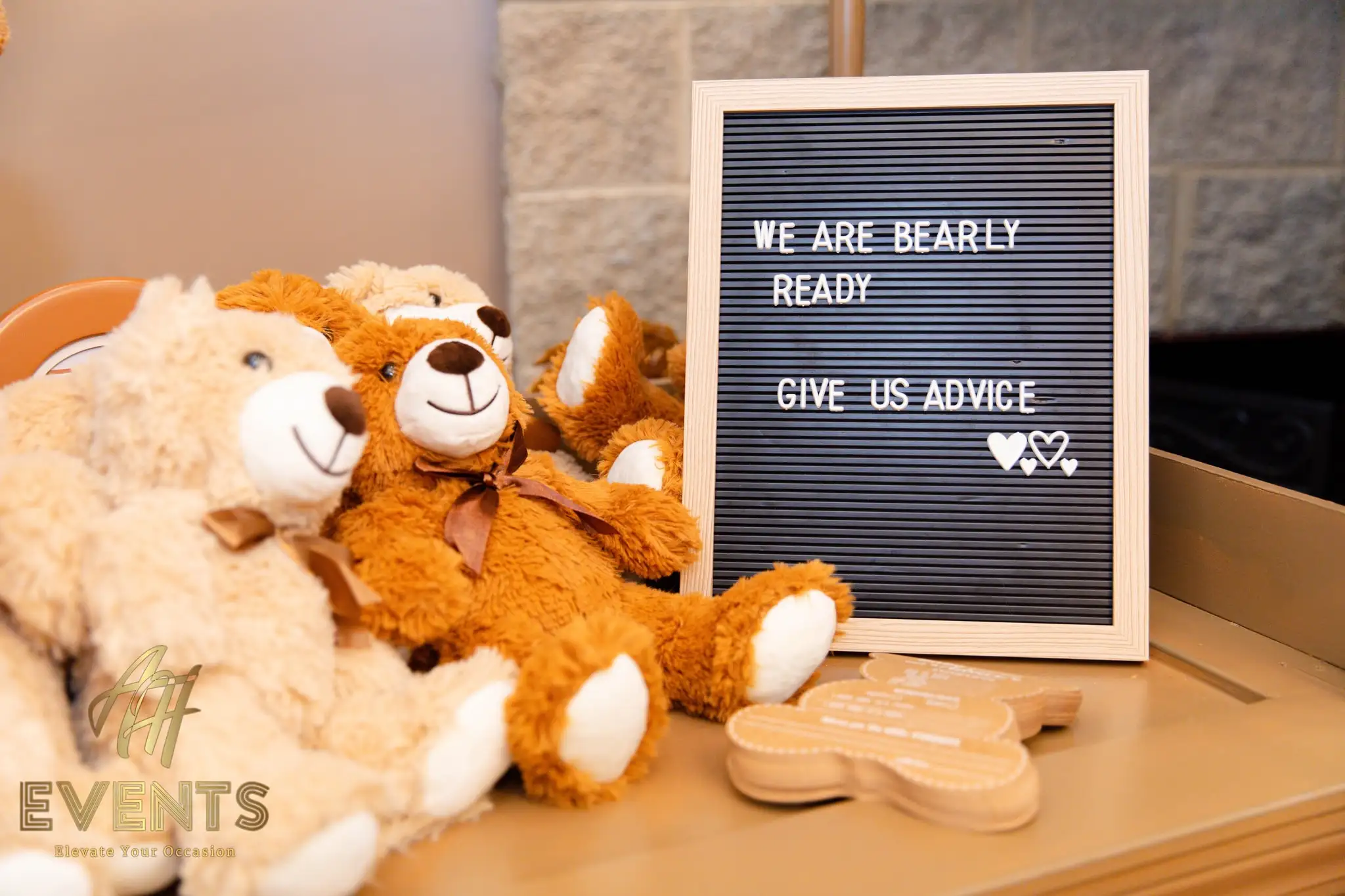 Three plush teddy bears beside a 'We are bearly ready — give us advice' letter board
