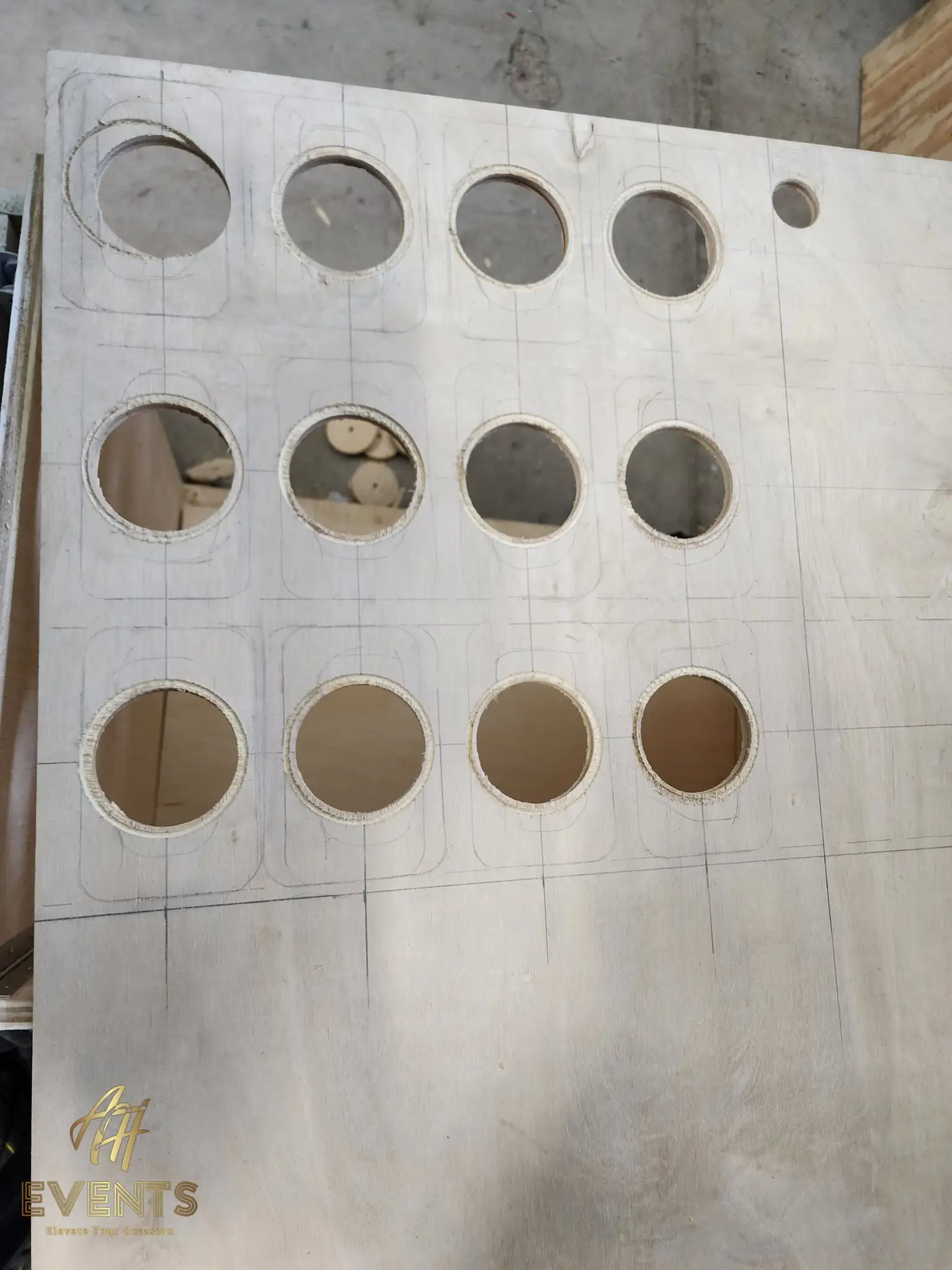 Plywood cart-top panel with a grid of circular cup holes cut through it