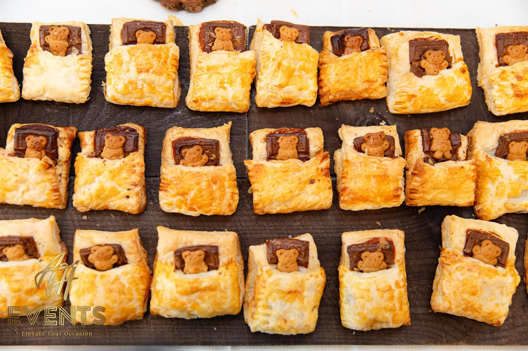 Close-up of teddy-bear-in-bed puff pastries with chocolate and bear-shaped cookies