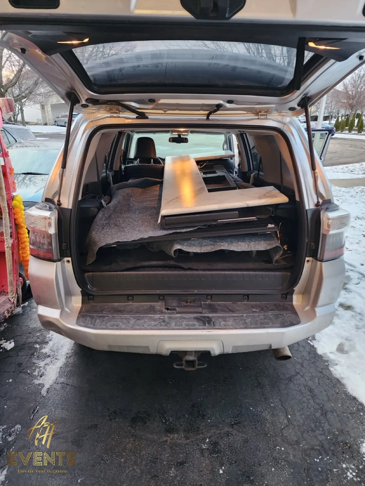 Folded Bobawala cart panels loaded flat into the back of an SUV for transport on a snowy day