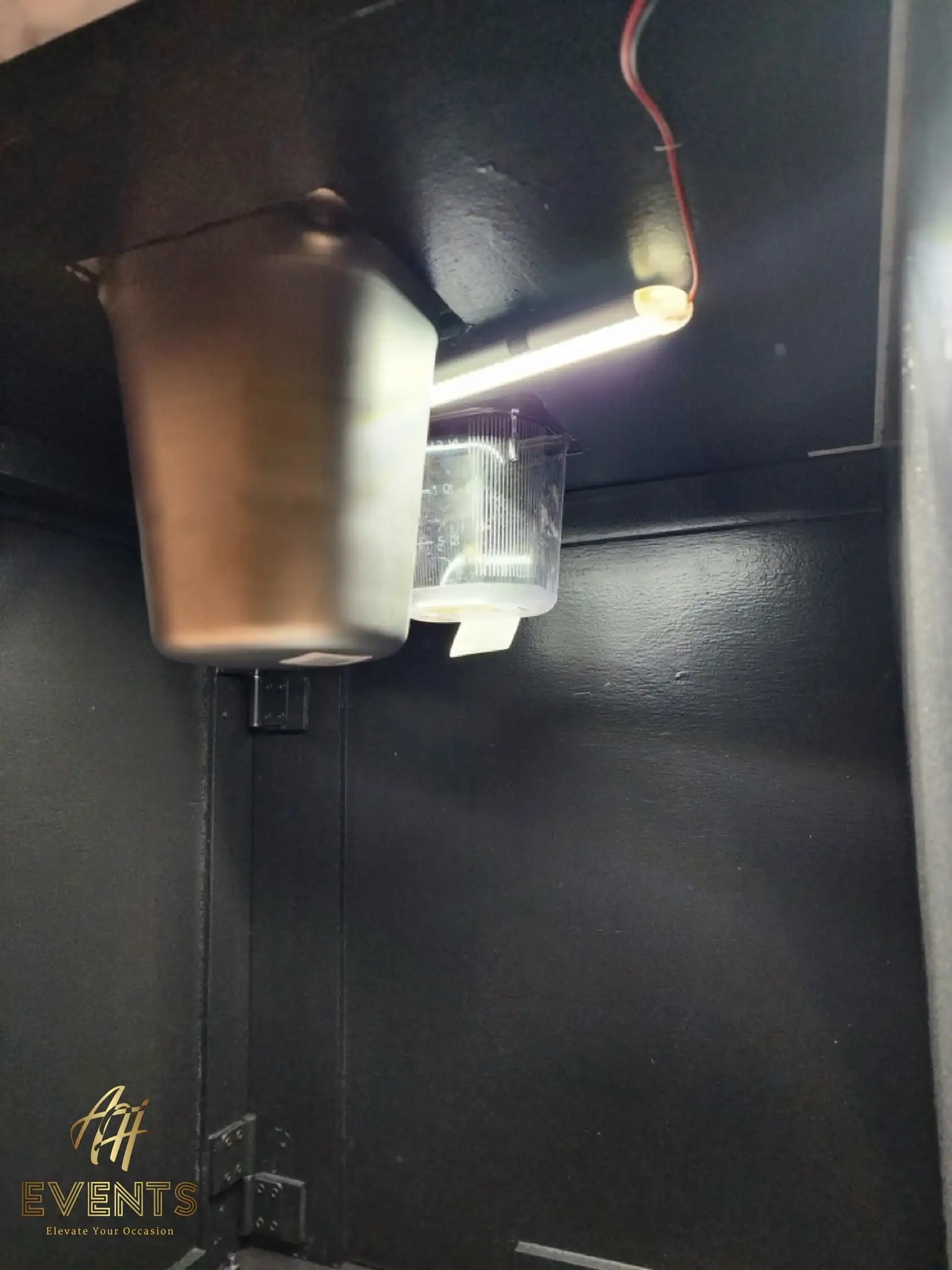 Under-counter stainless cup funnel and a warm LED strip inside the black Bobawala cart