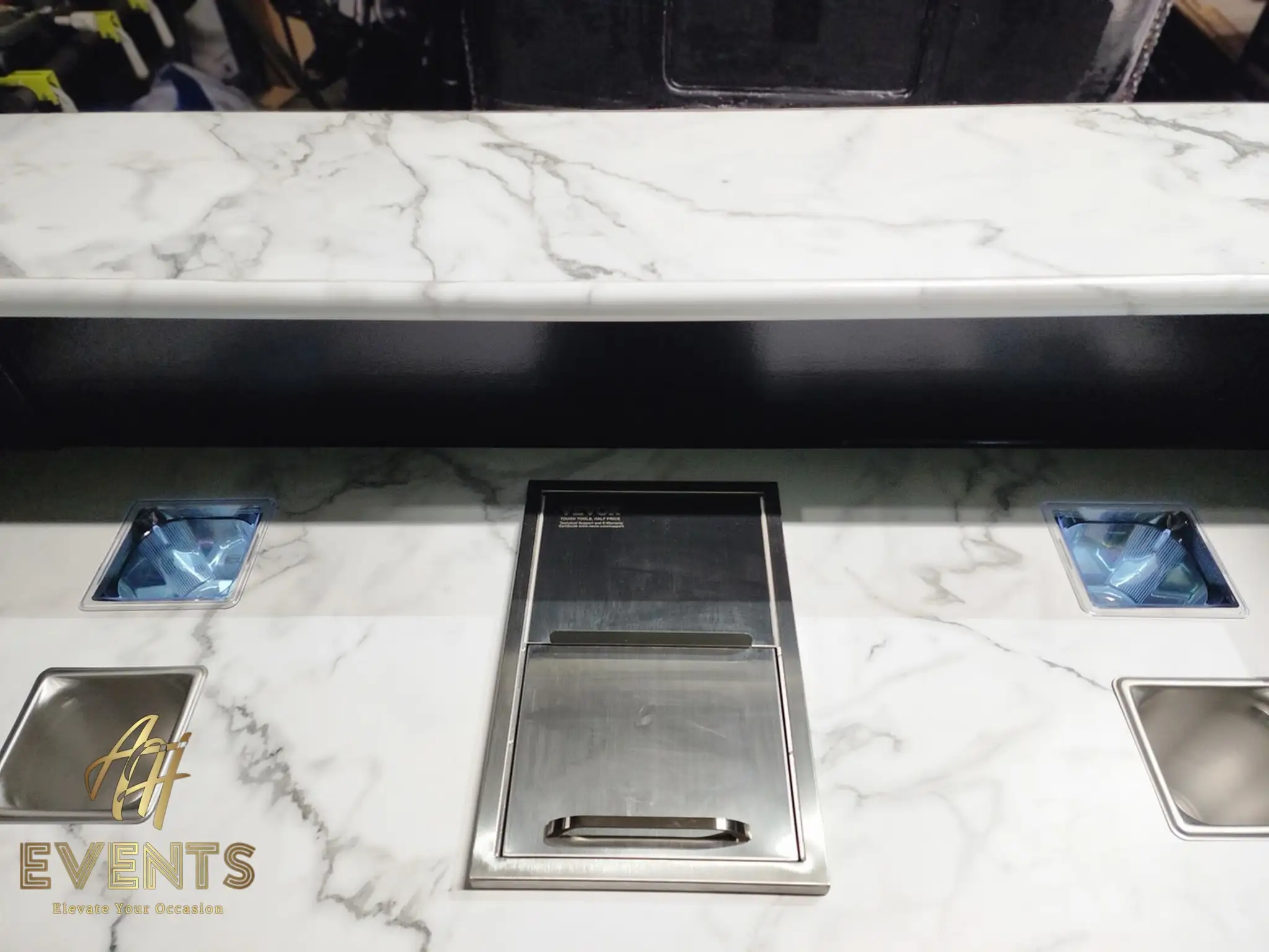 Bobawala cart marble counter with a central recessed stainless cup dispenser and blue-lined condiment wells