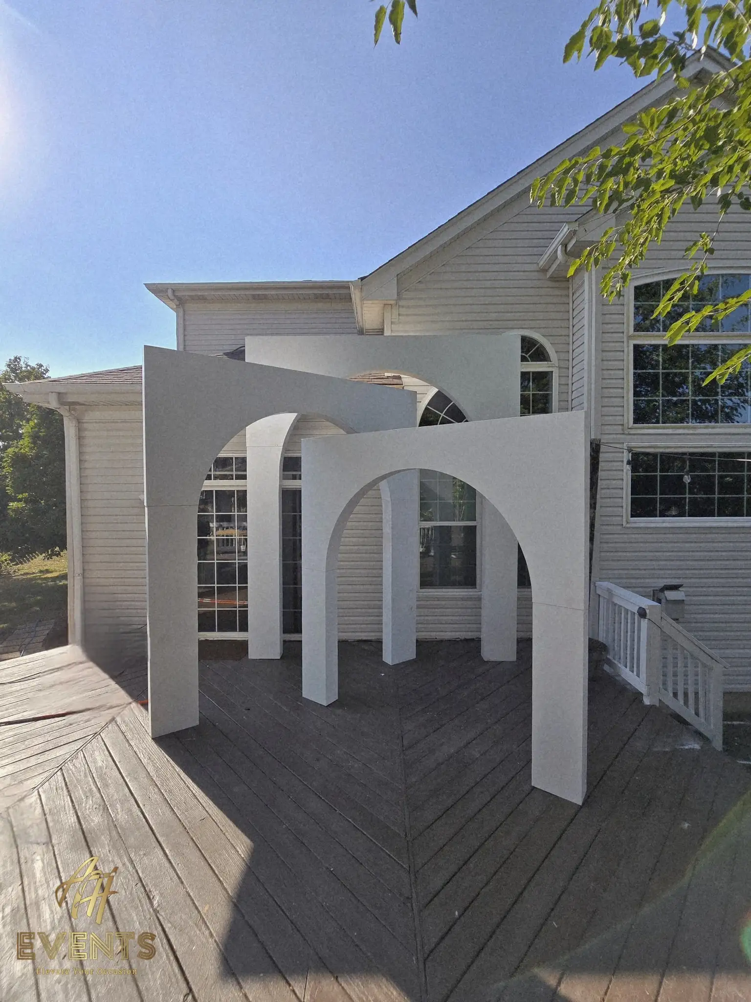 Wide view of the nested white volumetric arch suite on a deck