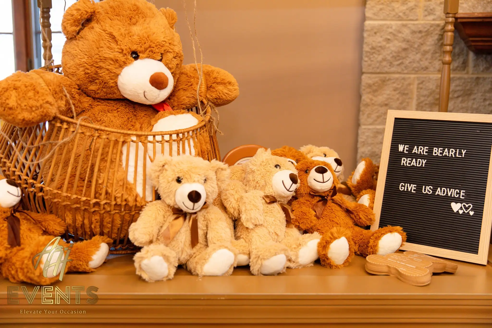Teddy bears in a basket beside the 'We are bearly ready' advice board on a gold console