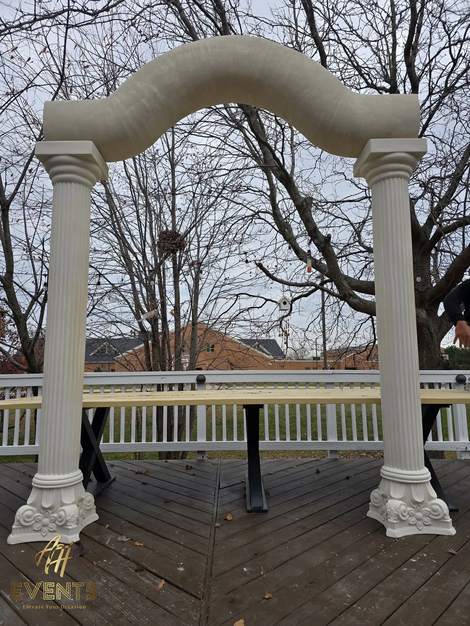 Front view of the two fluted columns and the serpentine arch standing on the deck