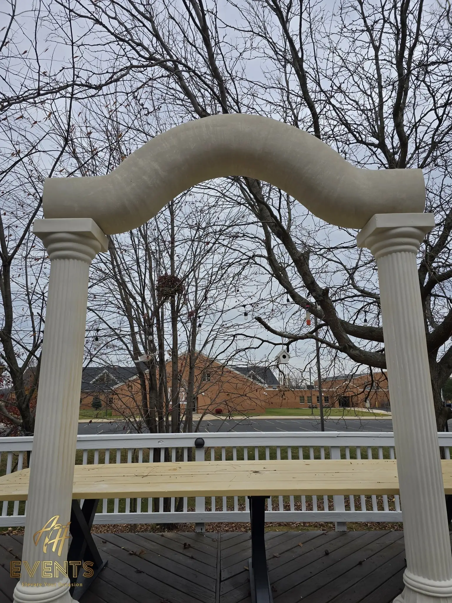 Fluted columns and serpentine arch with the plywood stage platform set in front