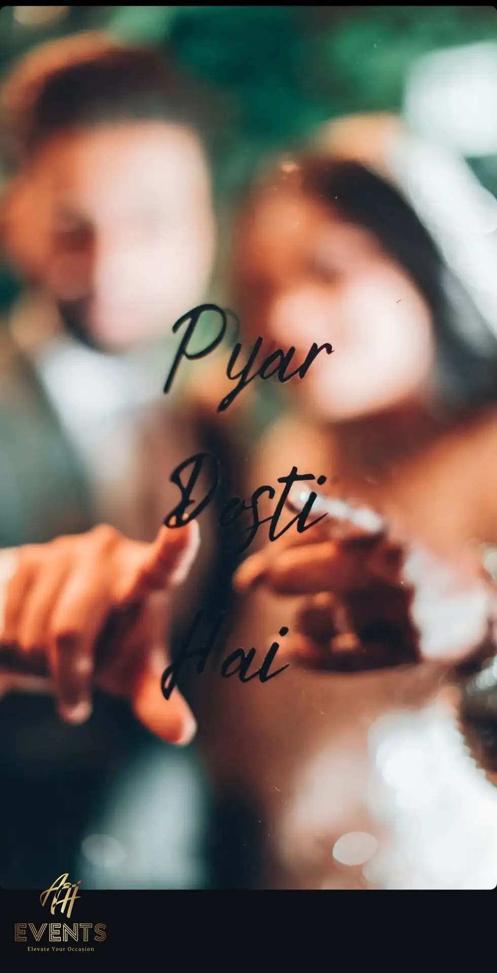 Couple pointing at a slogan from behind a glass photo booth panel