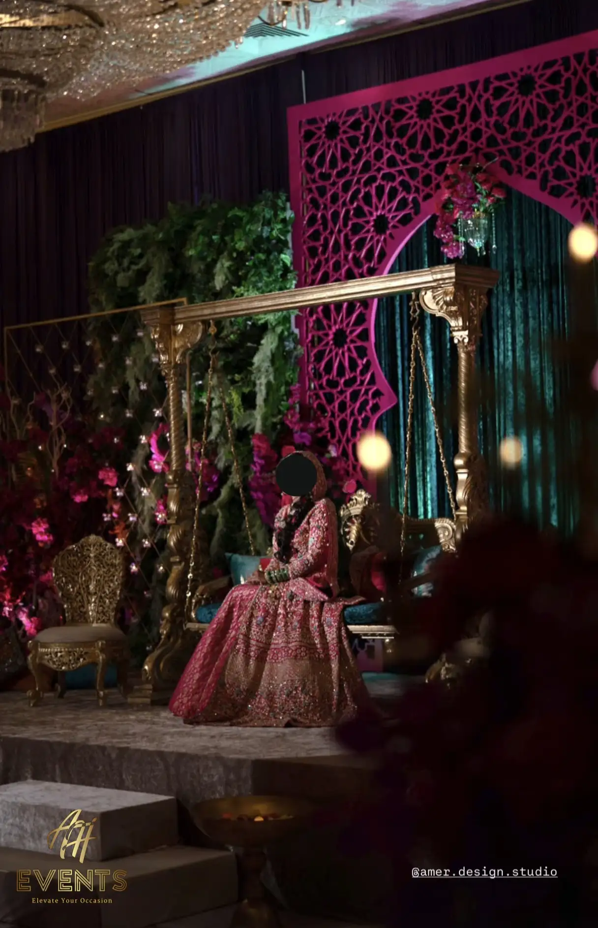 Bride sitting on stage in front of custom decor