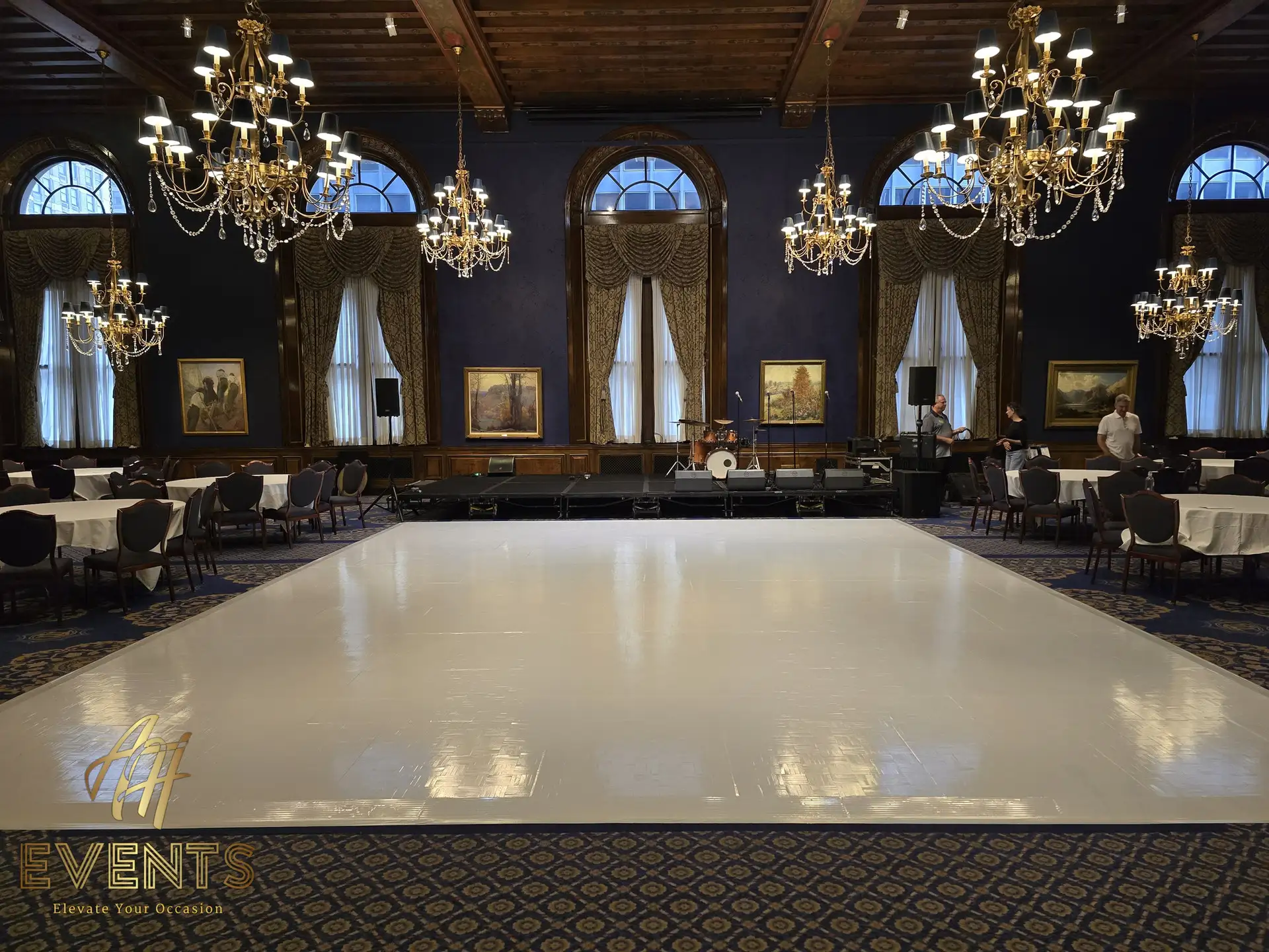 Seamless white vinyl dance floor by AH Events anchoring an elegant event space